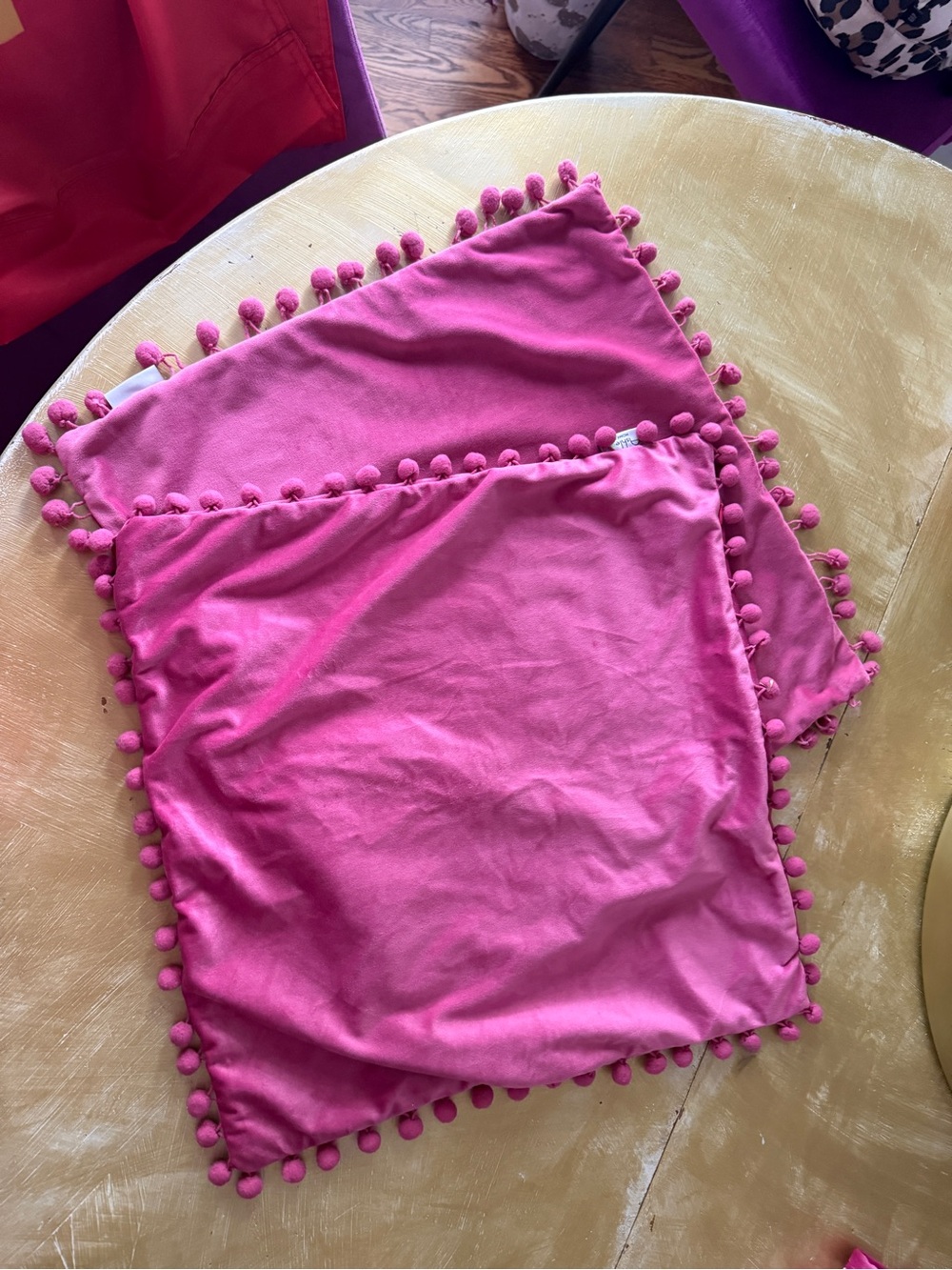 Pink pillow covers with Pom Pom’s